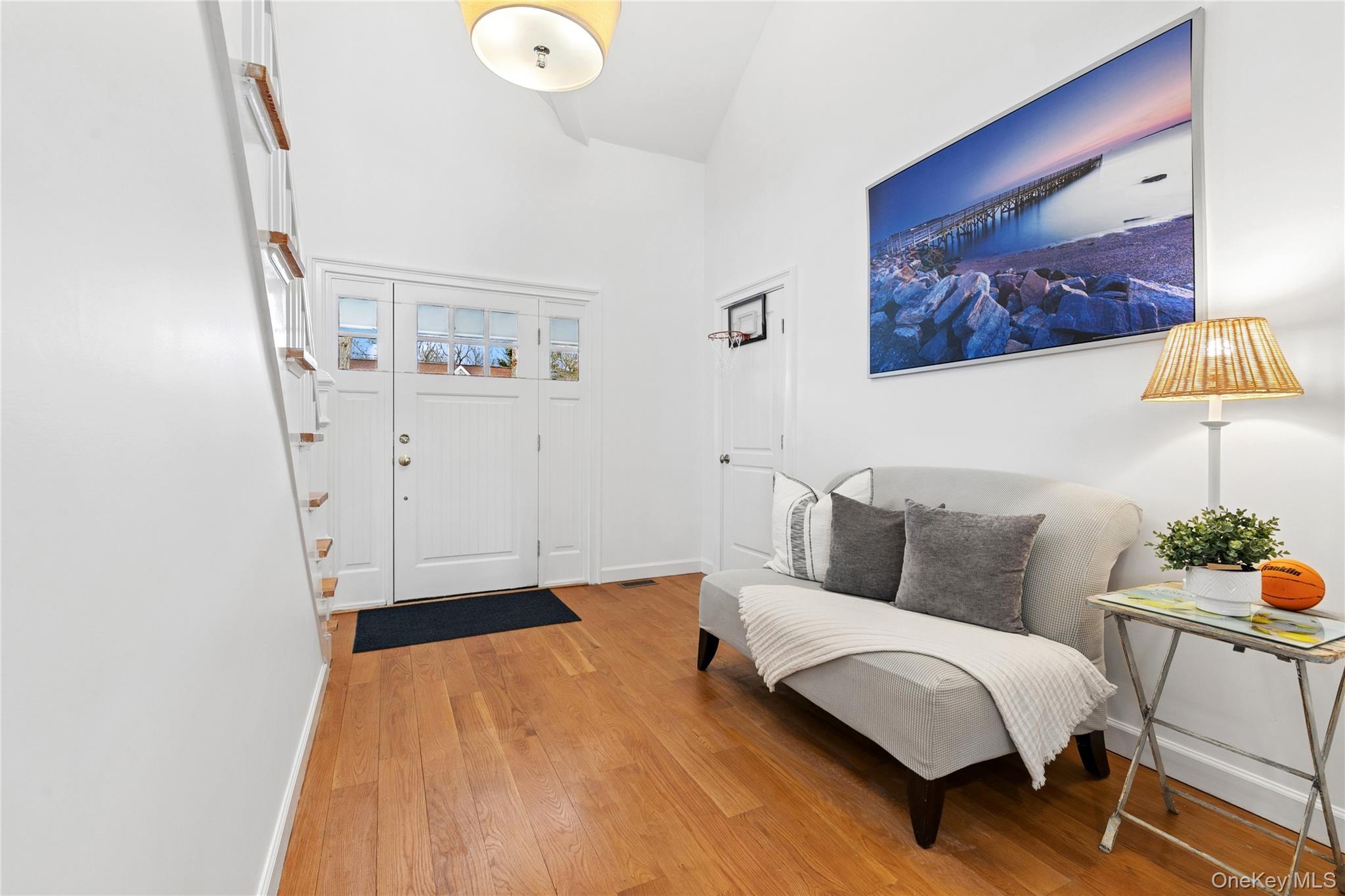 10 Foxboro Road East Quogue, NY 11946 - Photo 6 of 31 a bedroom with a bed and a lamp