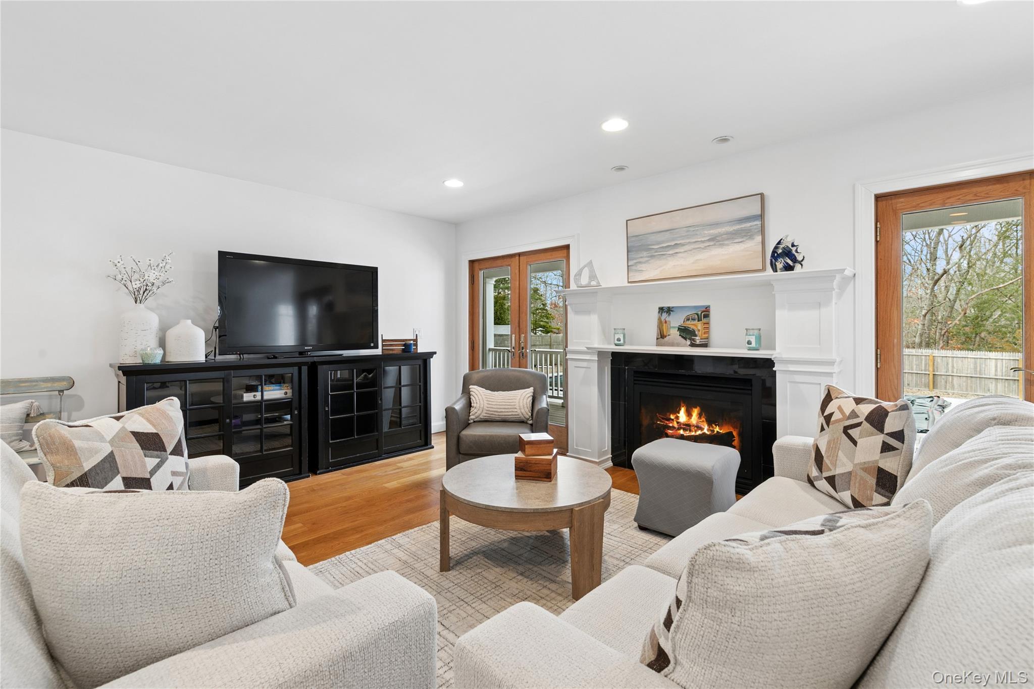 10 Foxboro Road East Quogue, NY 11946 - Photo 7 of 31 a living room with furniture a fireplace and a flat screen tv
