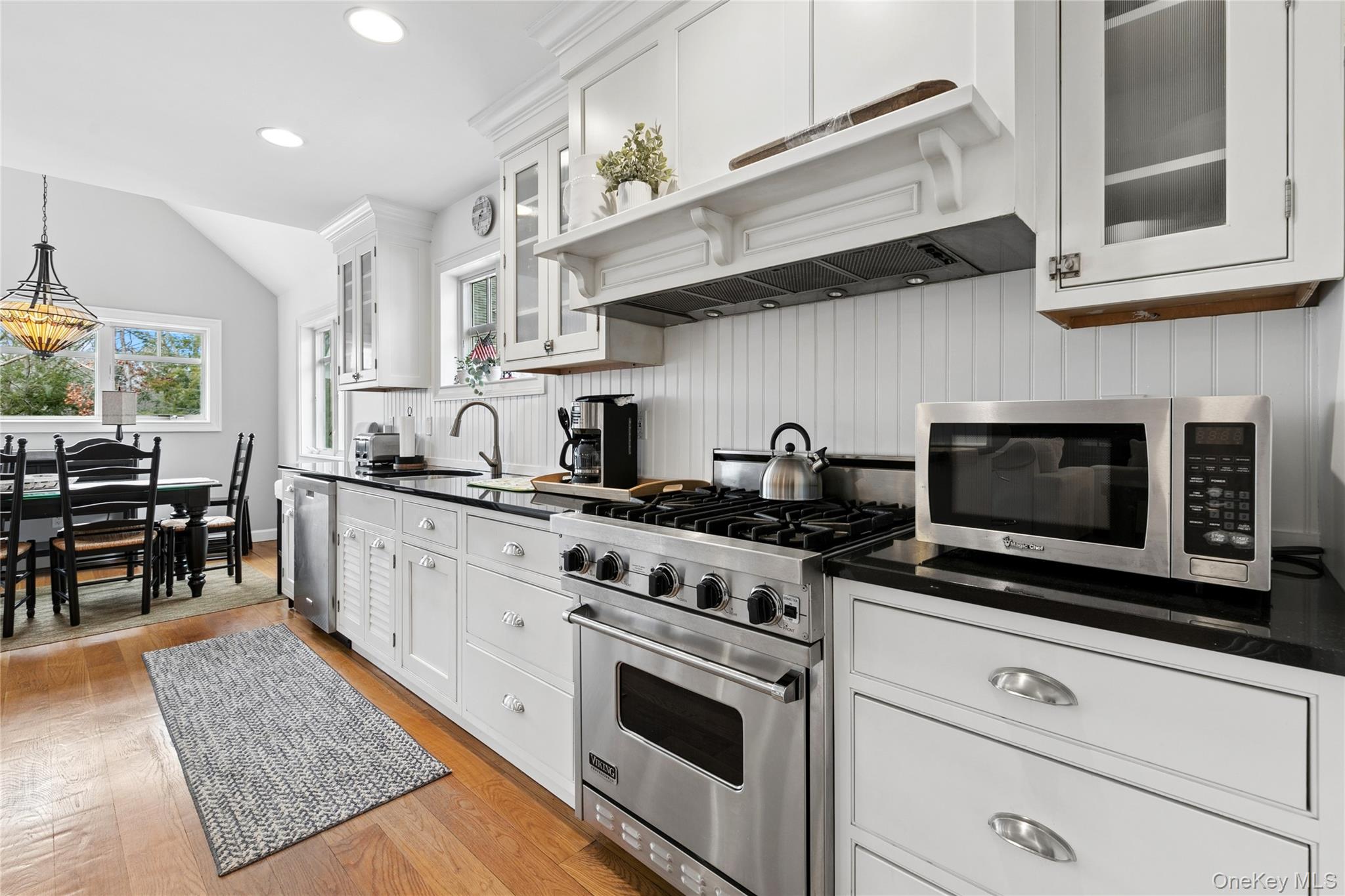 10 Foxboro Road East Quogue, NY 11946 - Photo 10 of 31 a kitchen with stainless steel appliances granite countertop a stove and a microwave