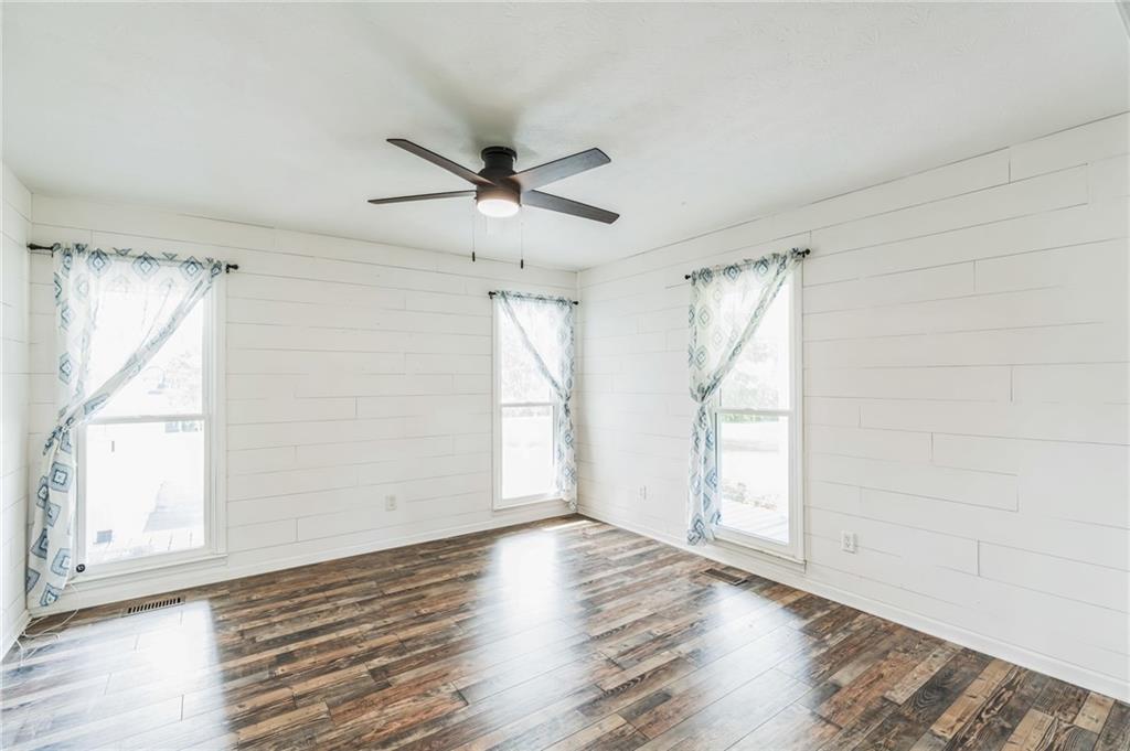 500 Coleman Mill Road Carrollton, GA 30116 - Photo 6 of 83 a view of empty room with wooden floor and fan