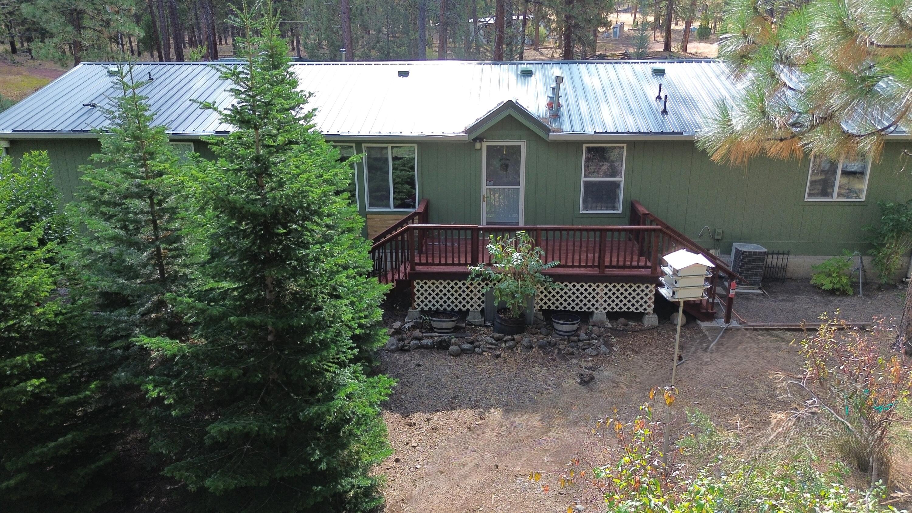 a view of a house with a yard patio and furniture