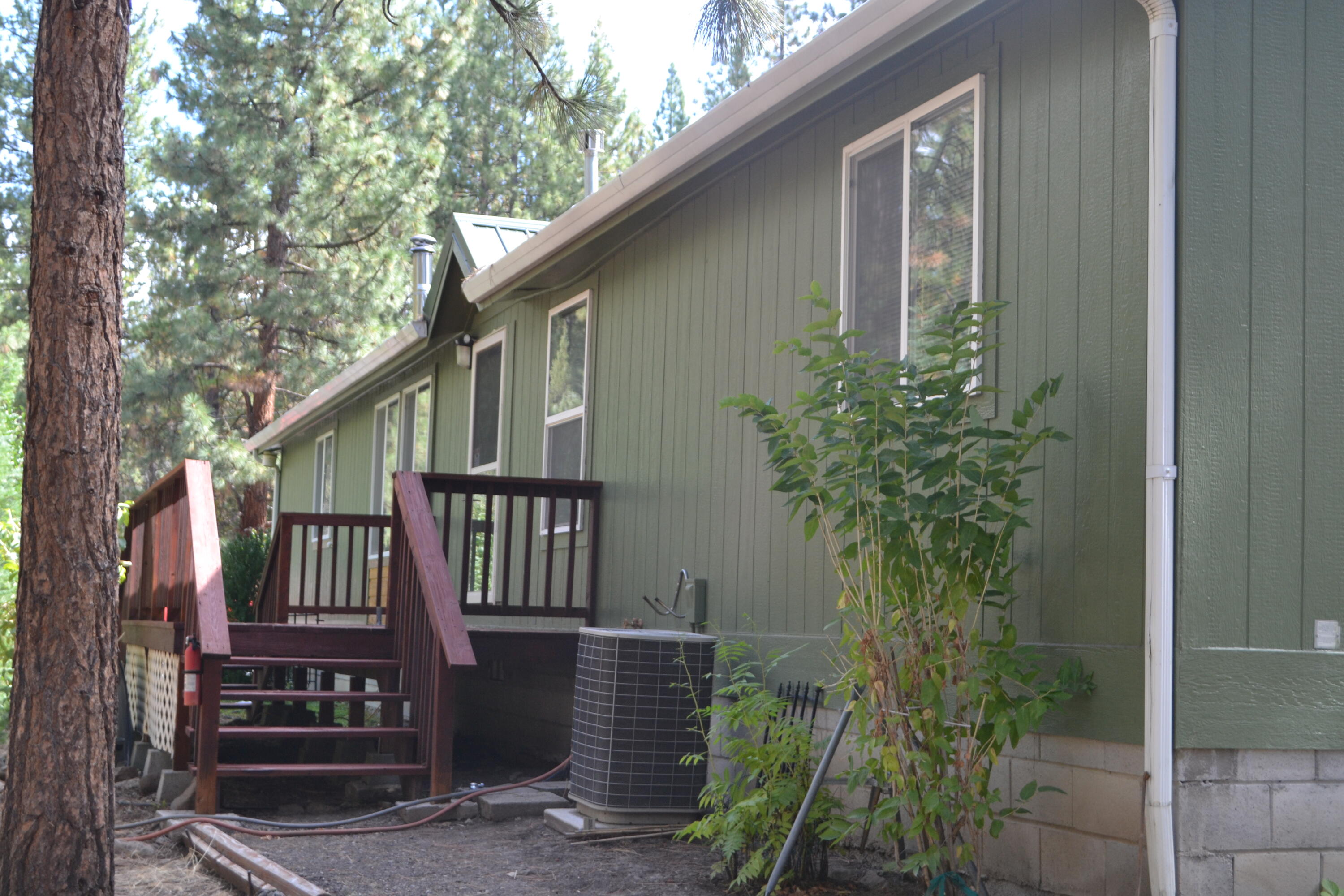 34 Hideaway Lane Adin, CA 96006 - Photo 18 of 26 a view of a house with a small yard and wooden fence