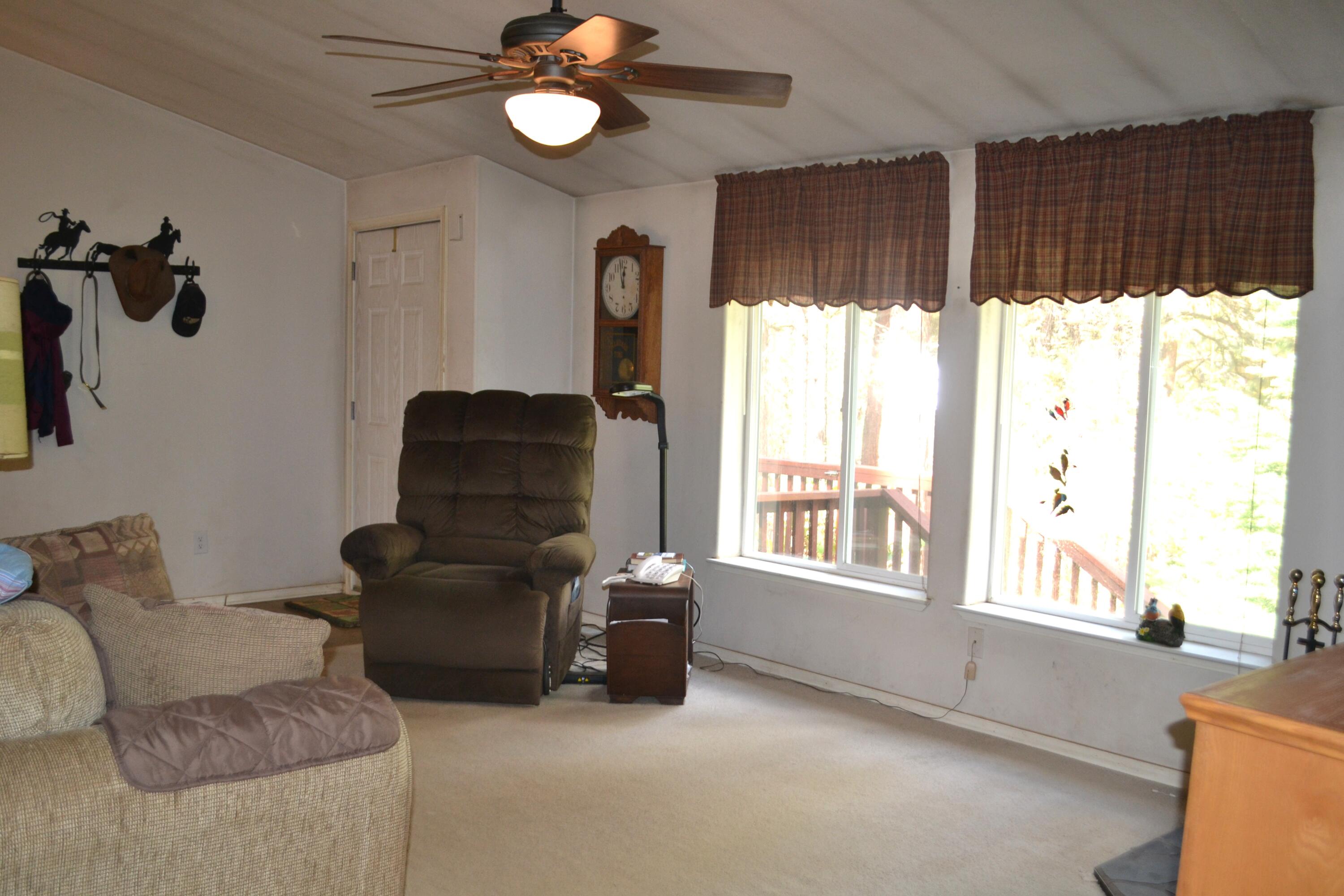 34 Hideaway Lane Adin, CA 96006 - Photo 4 of 26 a living room with furniture and a large window