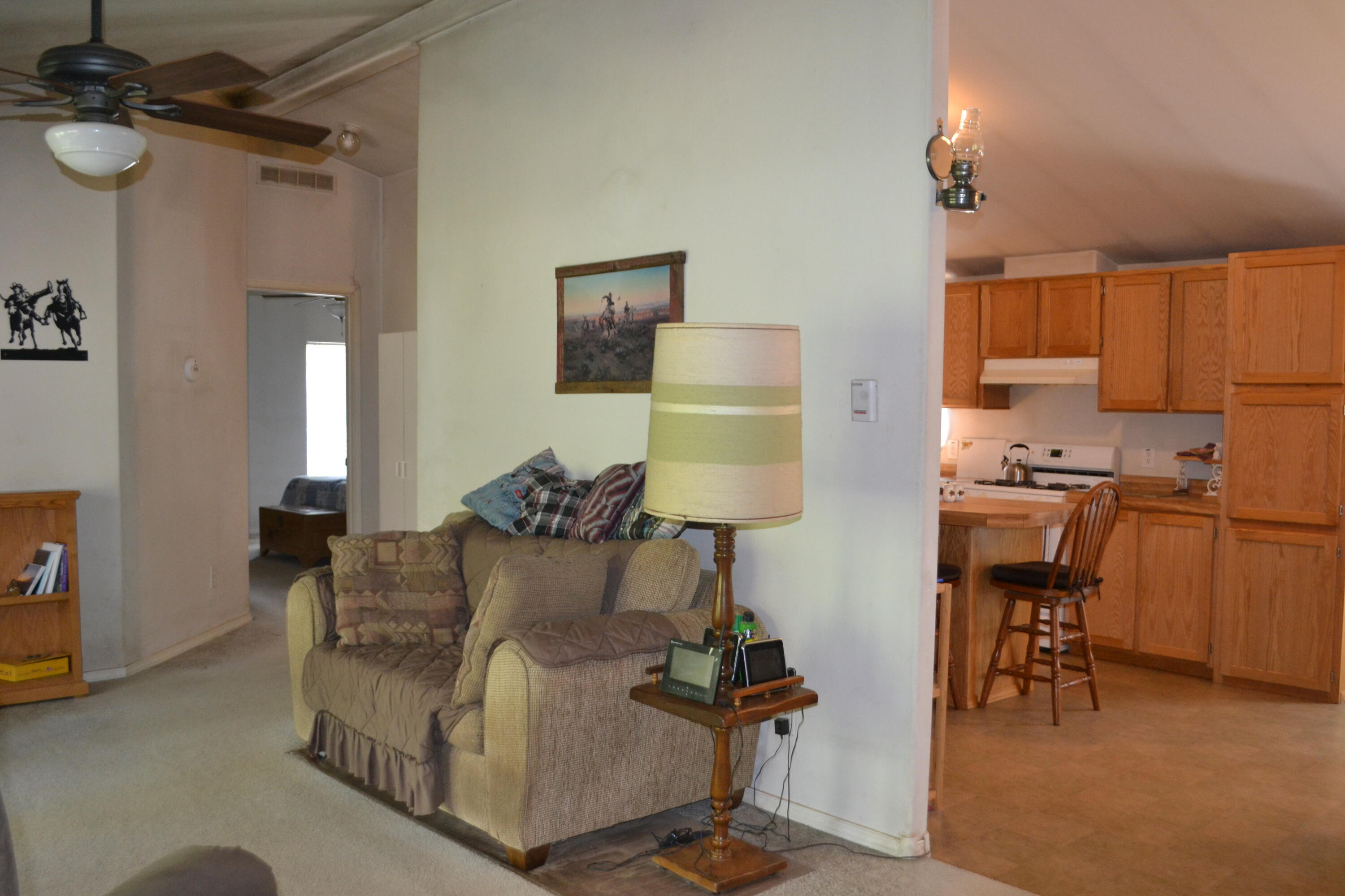 34 Hideaway Lane Adin, CA 96006 - Photo 5 of 26 a living room with furniture a dining table and chairs with wooden floor