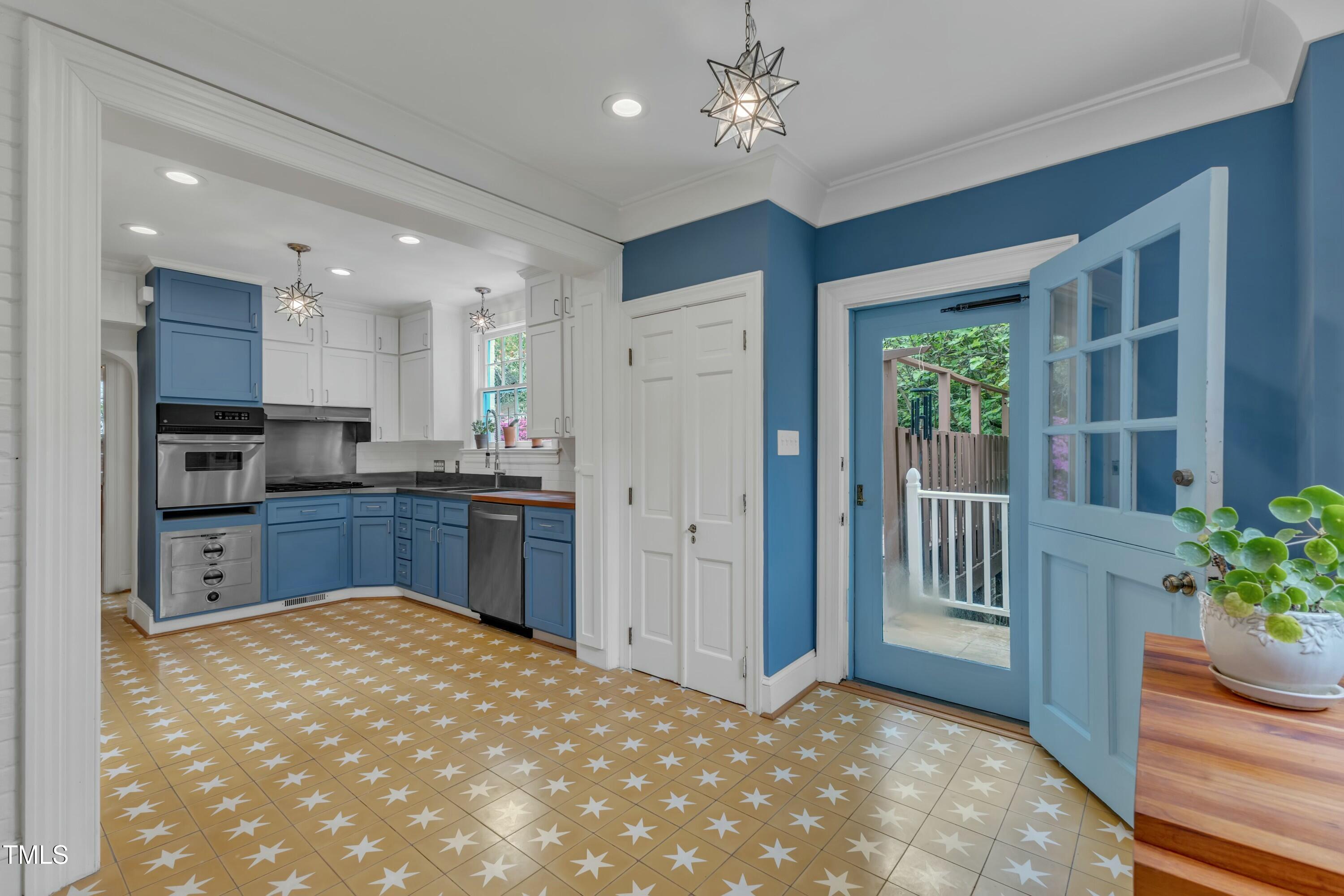 2625 Dover Road Raleigh, NC 27608 - Photo 24 of 90 a kitchen with kitchen island a stove a refrigerator and a sink
