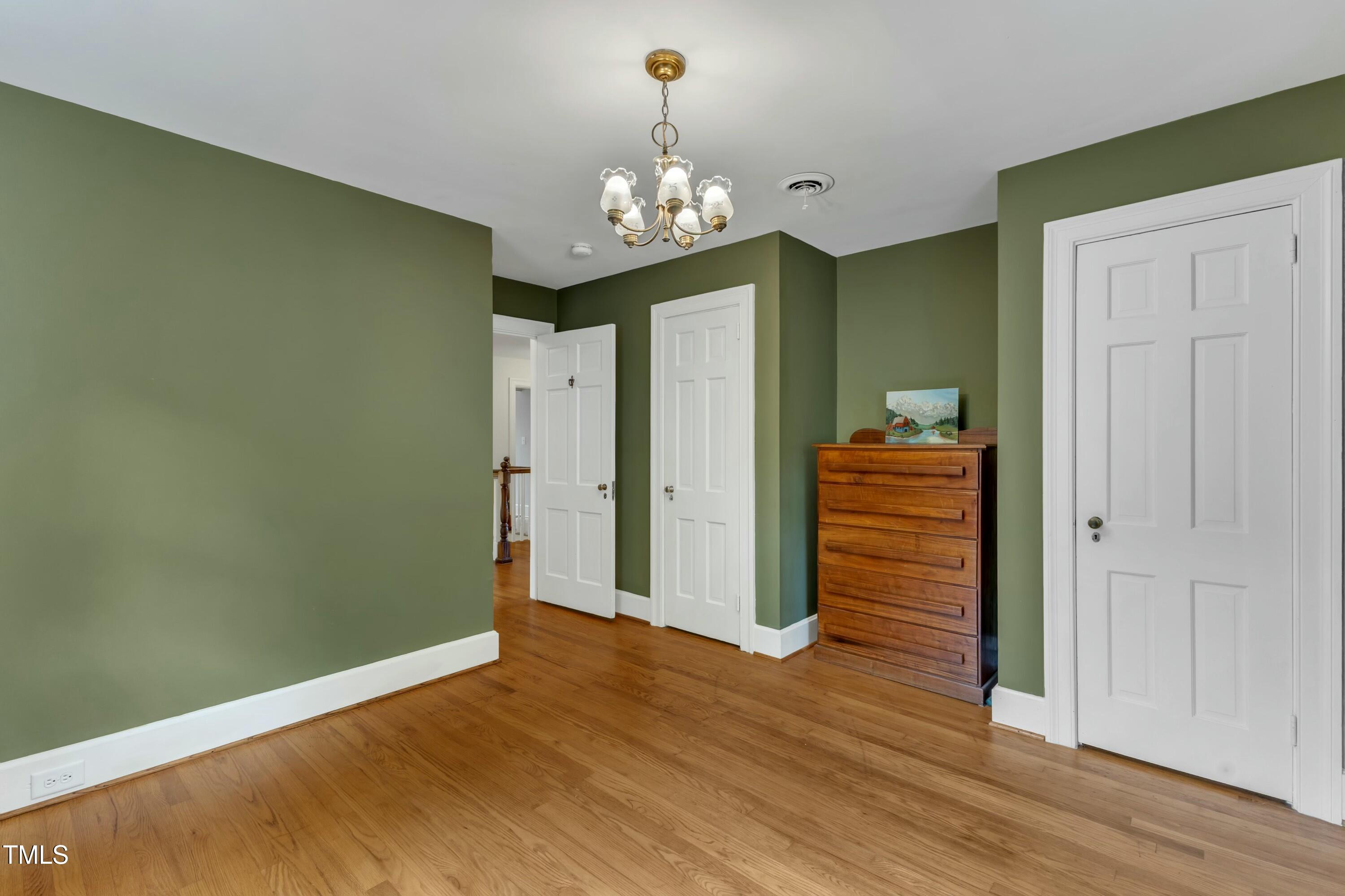 2625 Dover Road Raleigh, NC 27608 - Photo 41 of 90 a view of an empty room with wooden floor and a front door