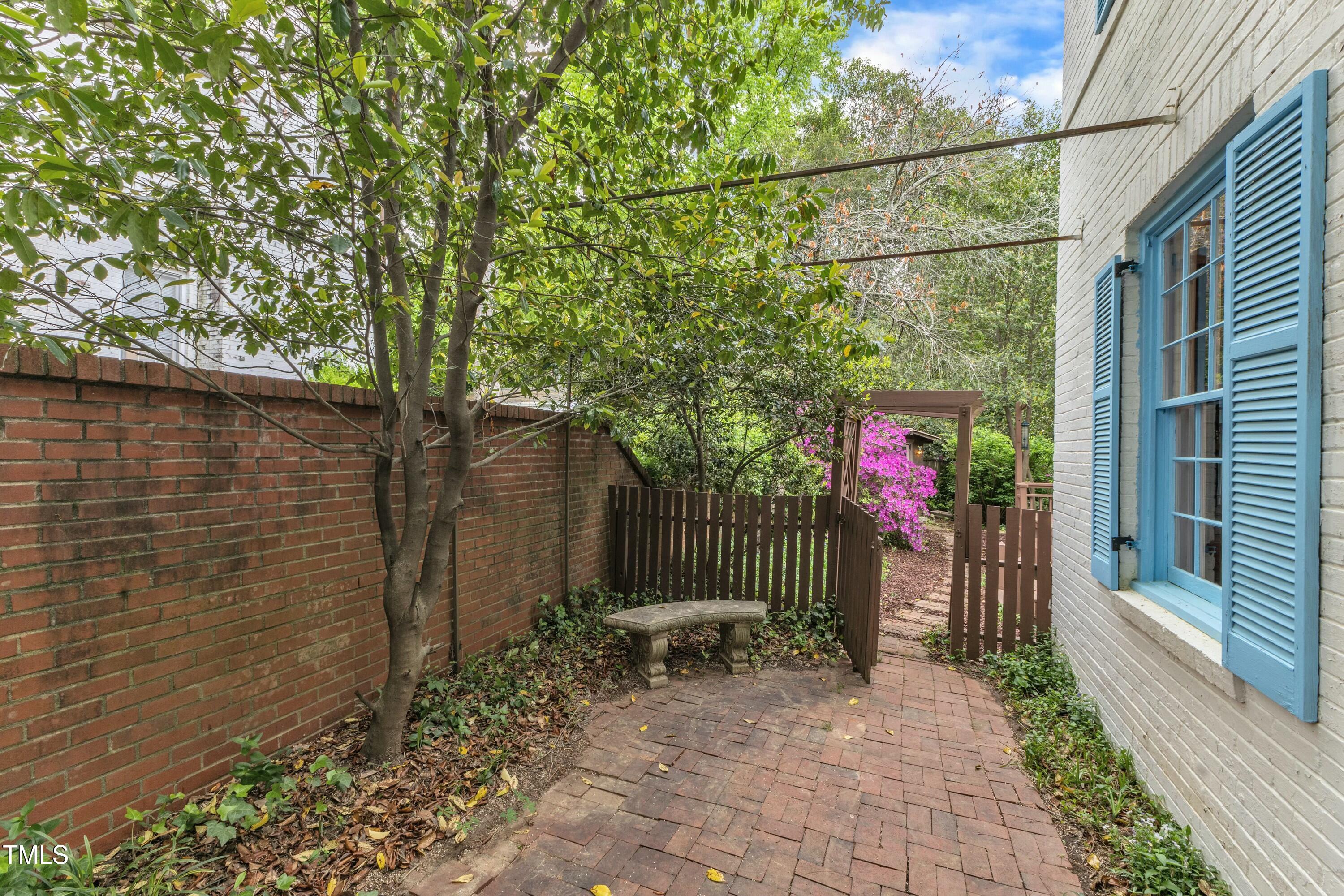 2625 Dover Road Raleigh, NC 27608 - Photo 61 of 90 a backyard of a house with table and chairs and wooden fence