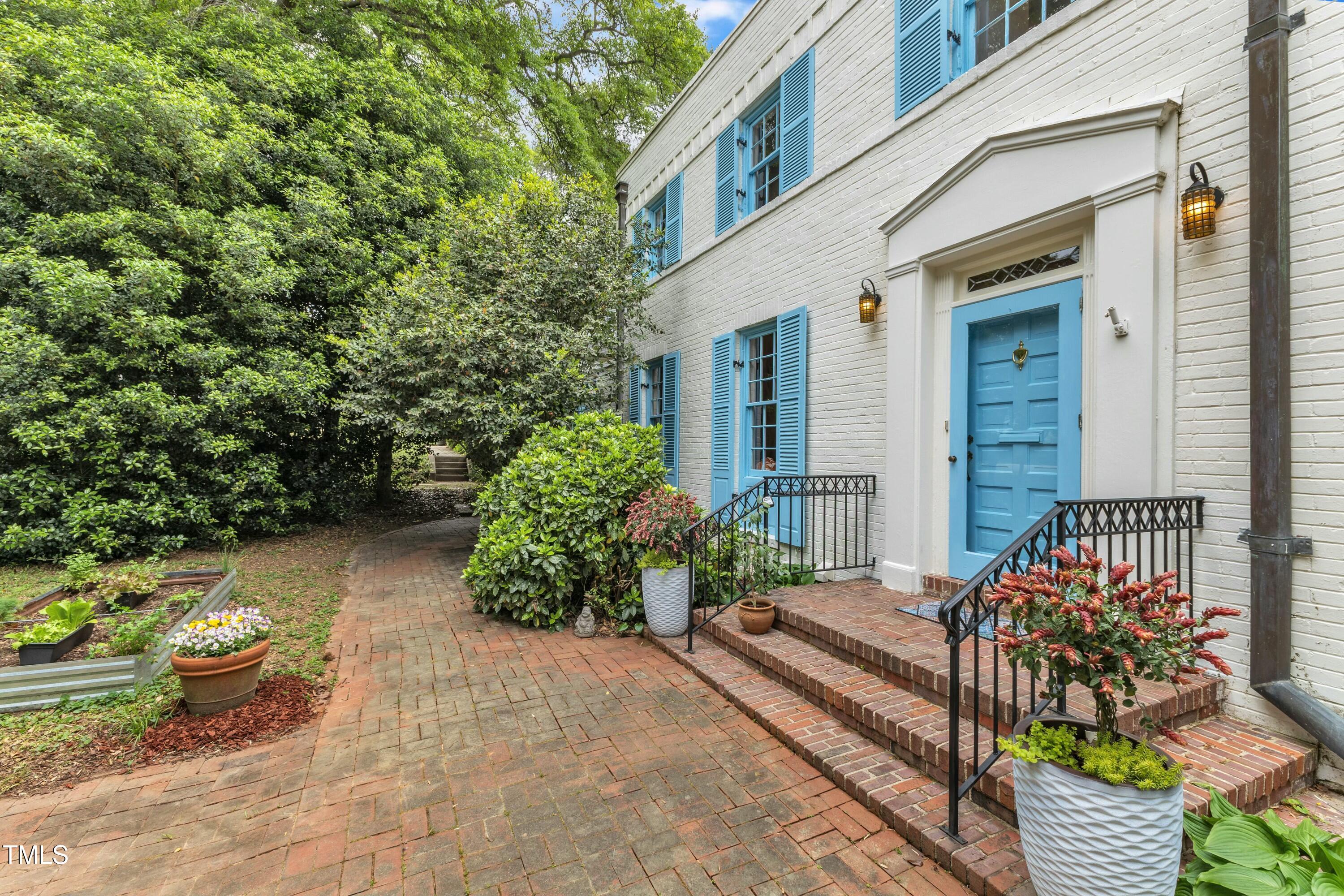 2625 Dover Road Raleigh, NC 27608 - Photo 6 of 90 a view of a backyard with chairs and potted plants