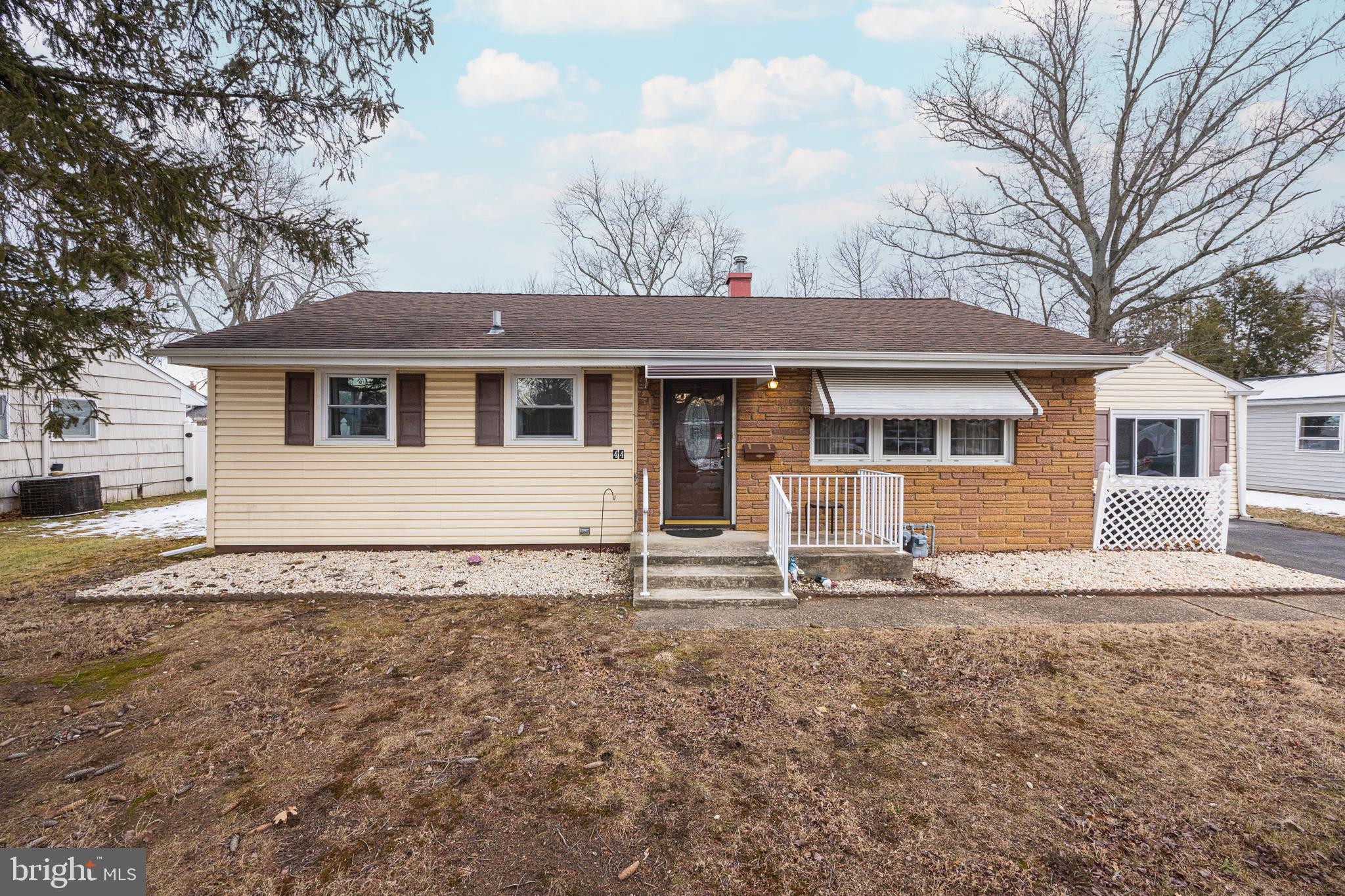 a house that has a tree in front of the house