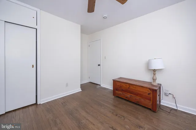 a room with wooden floor and glass door