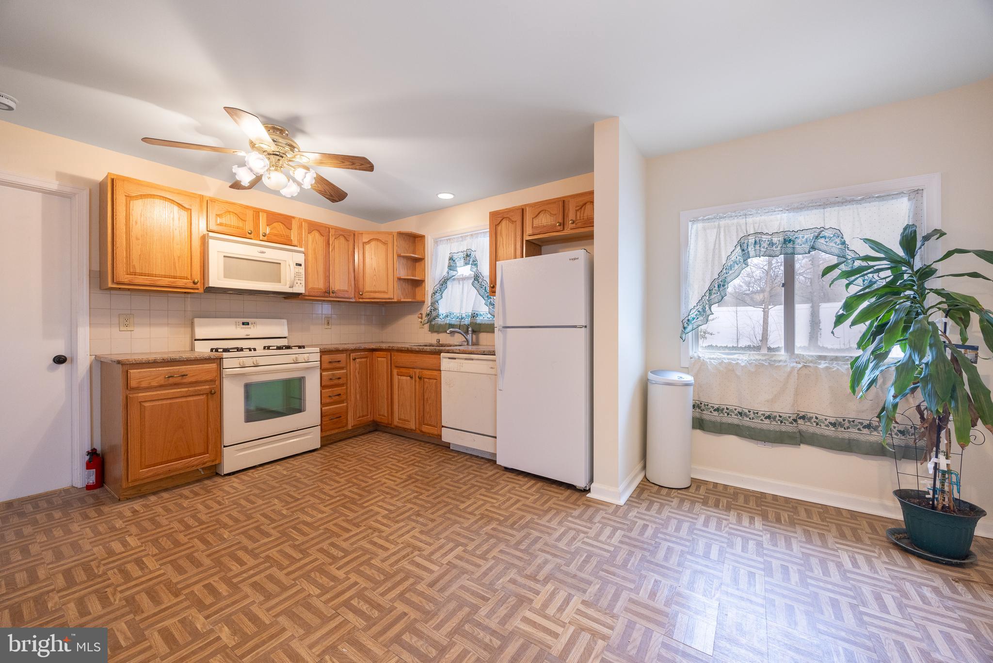 44 Matthew Drive Hamilton, NJ 08690 - Photo 3 of 27 a kitchen with stainless steel appliances granite countertop a refrigerator a stove a sink and a microwave