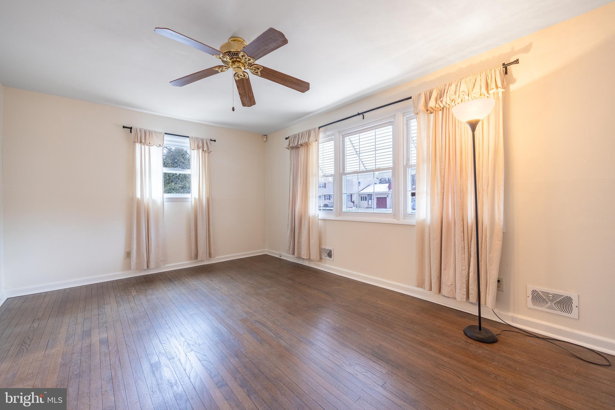 44 Matthew Drive Hamilton, NJ 08690 - Photo 5 of 27 a view of an empty room with a window and wooden floor