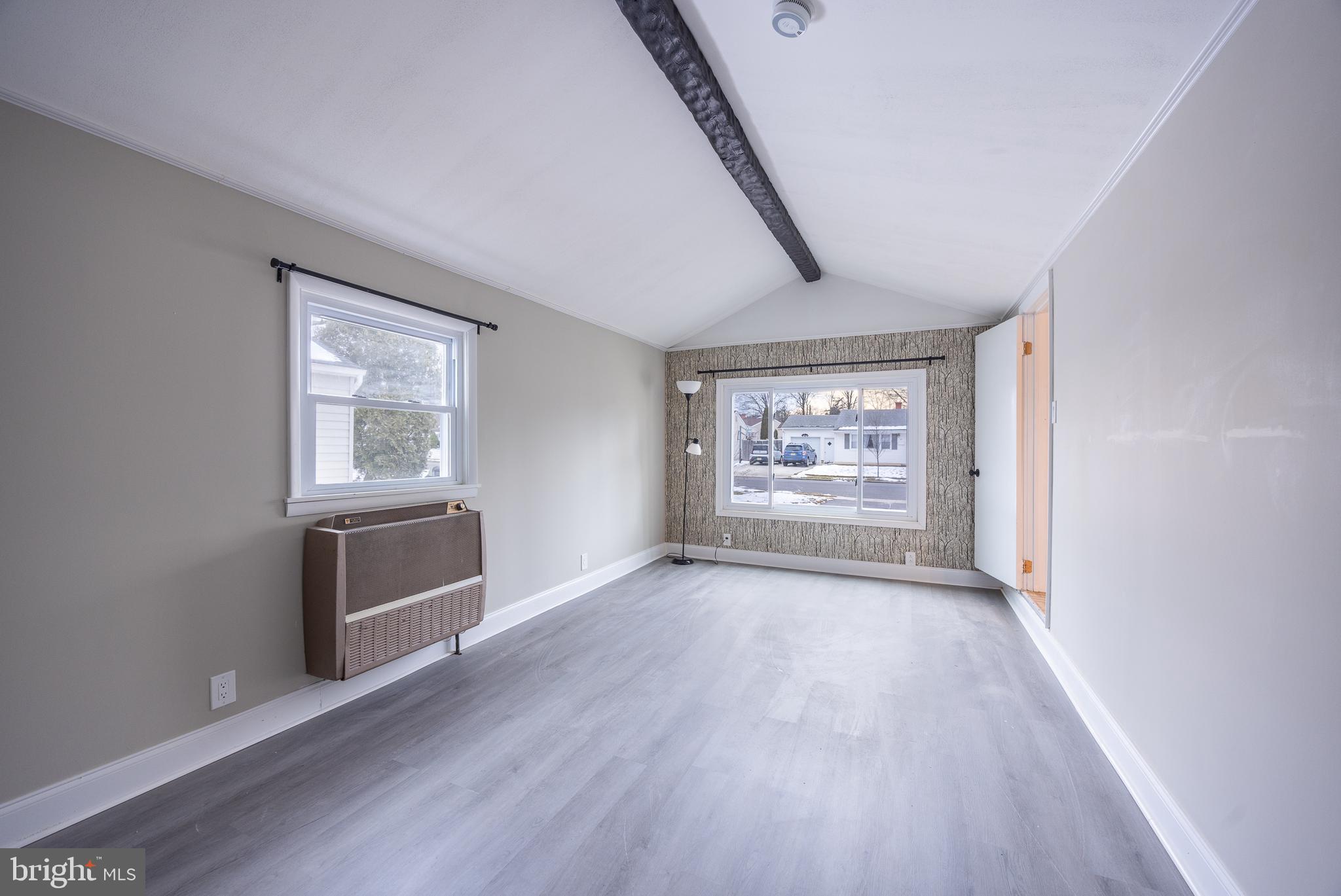 44 Matthew Drive Hamilton, NJ 08690 - Photo 7 of 27 a view of an empty room with a window and wooden floor