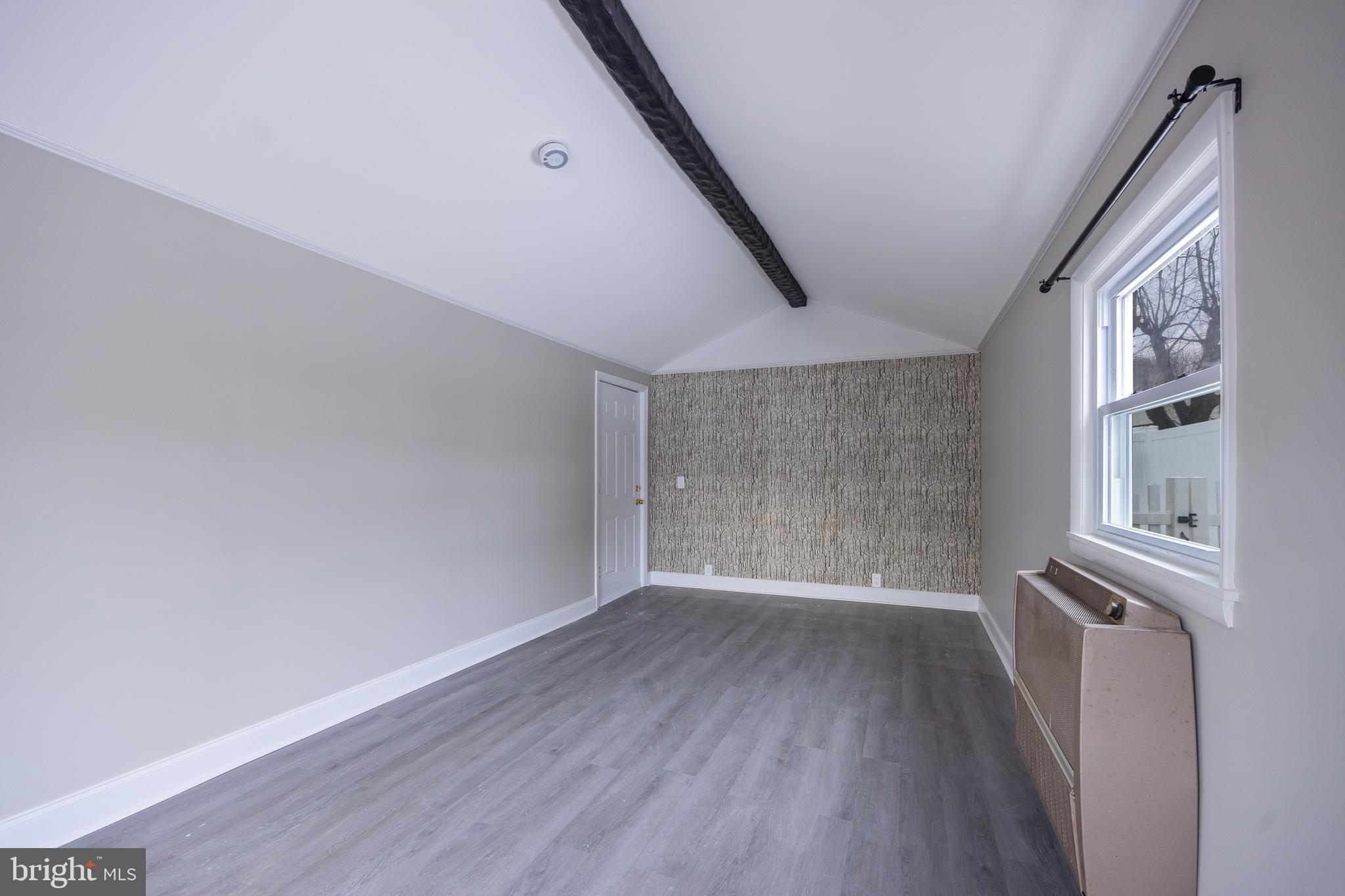 44 Matthew Drive Hamilton, NJ 08690 - Photo 9 of 27 a view of an empty room with wooden floor and a window