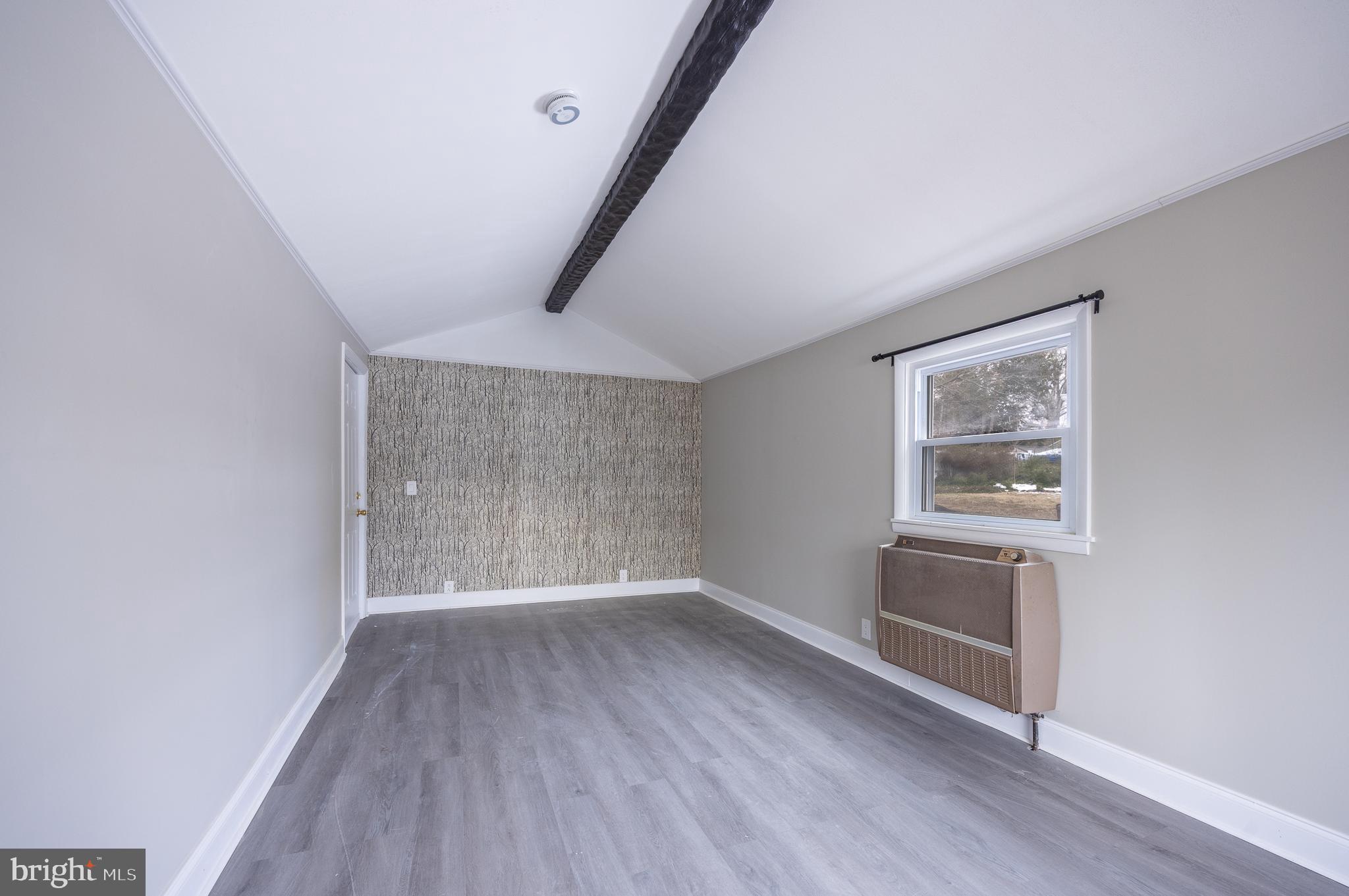 44 Matthew Drive Hamilton, NJ 08690 - Photo 10 of 27 an empty room with wooden floor and windows