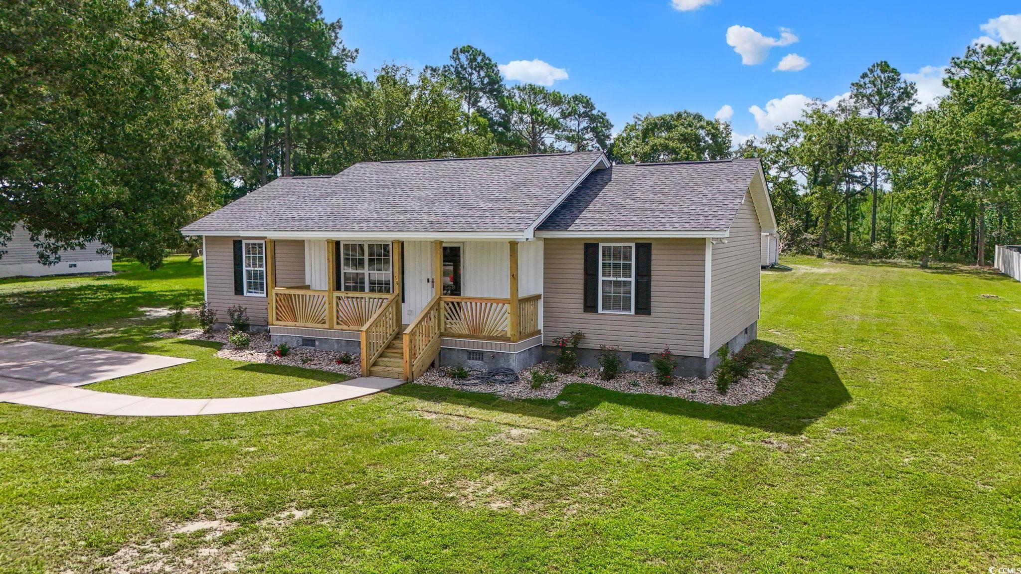 568 Rosedale Drive Aynor, SC 29511 - Photo 2 of 38 View of front of house with covered porch, crawl space, a shingled roof, and a front lawn