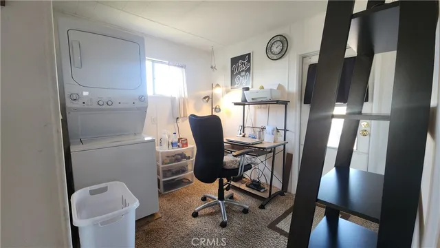 a view of workspace with lounge chair and window