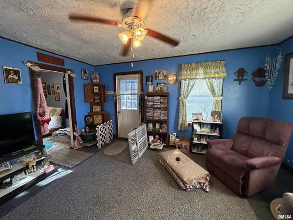 a living room with furniture a flat screen tv and a large window