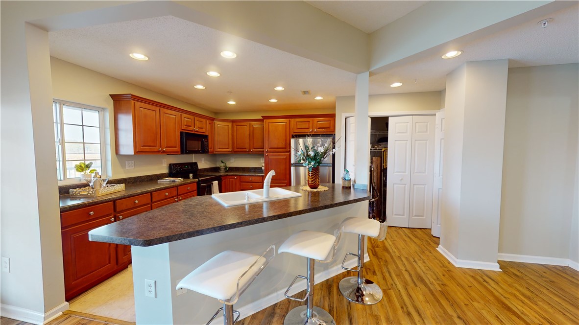 849 Tiger Boulevard, Unit 202 Clemson, SC 29631 - Photo 5 of 25 Kitchen island showing laundry closet