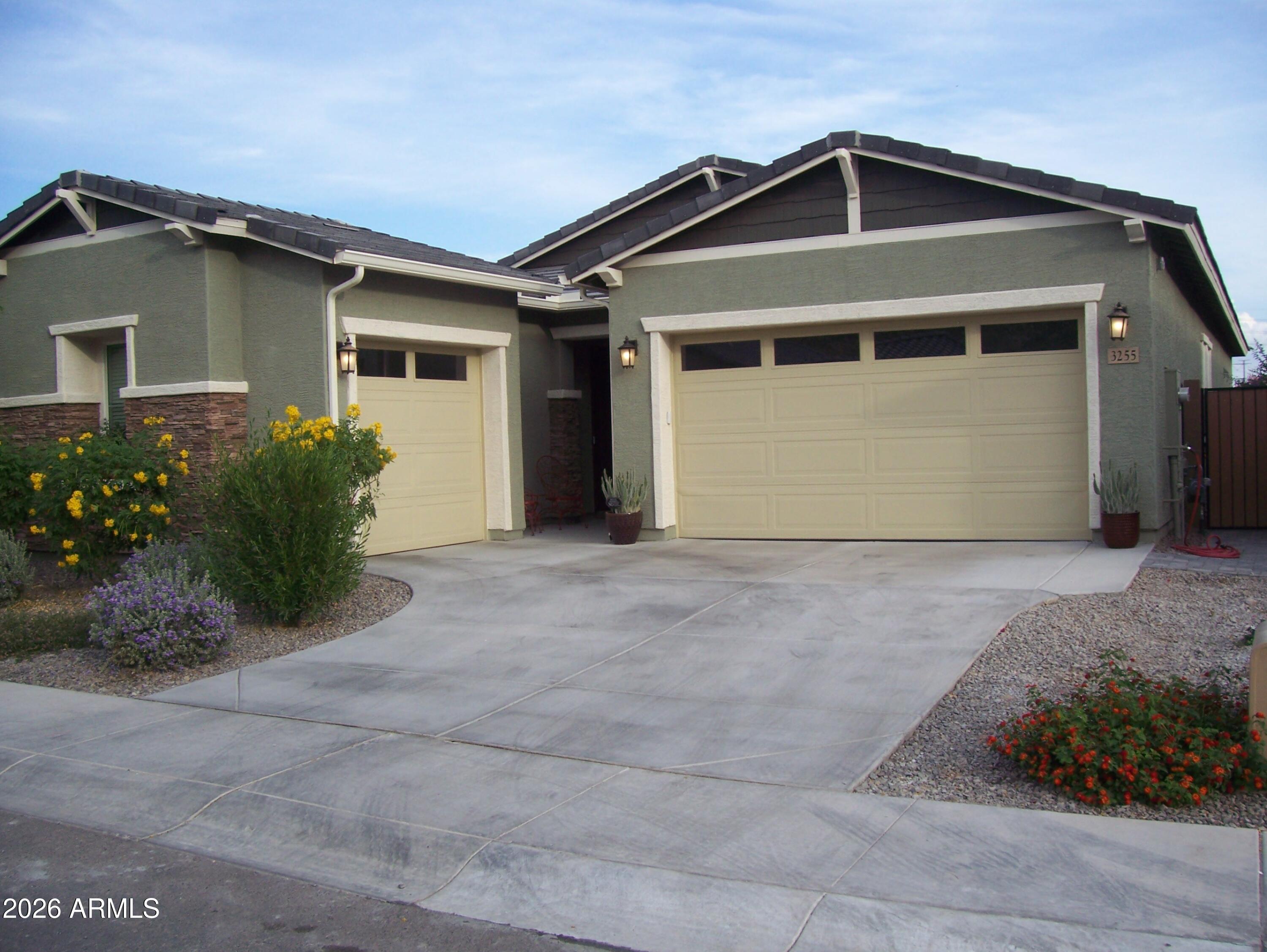 a front view of a house with garden