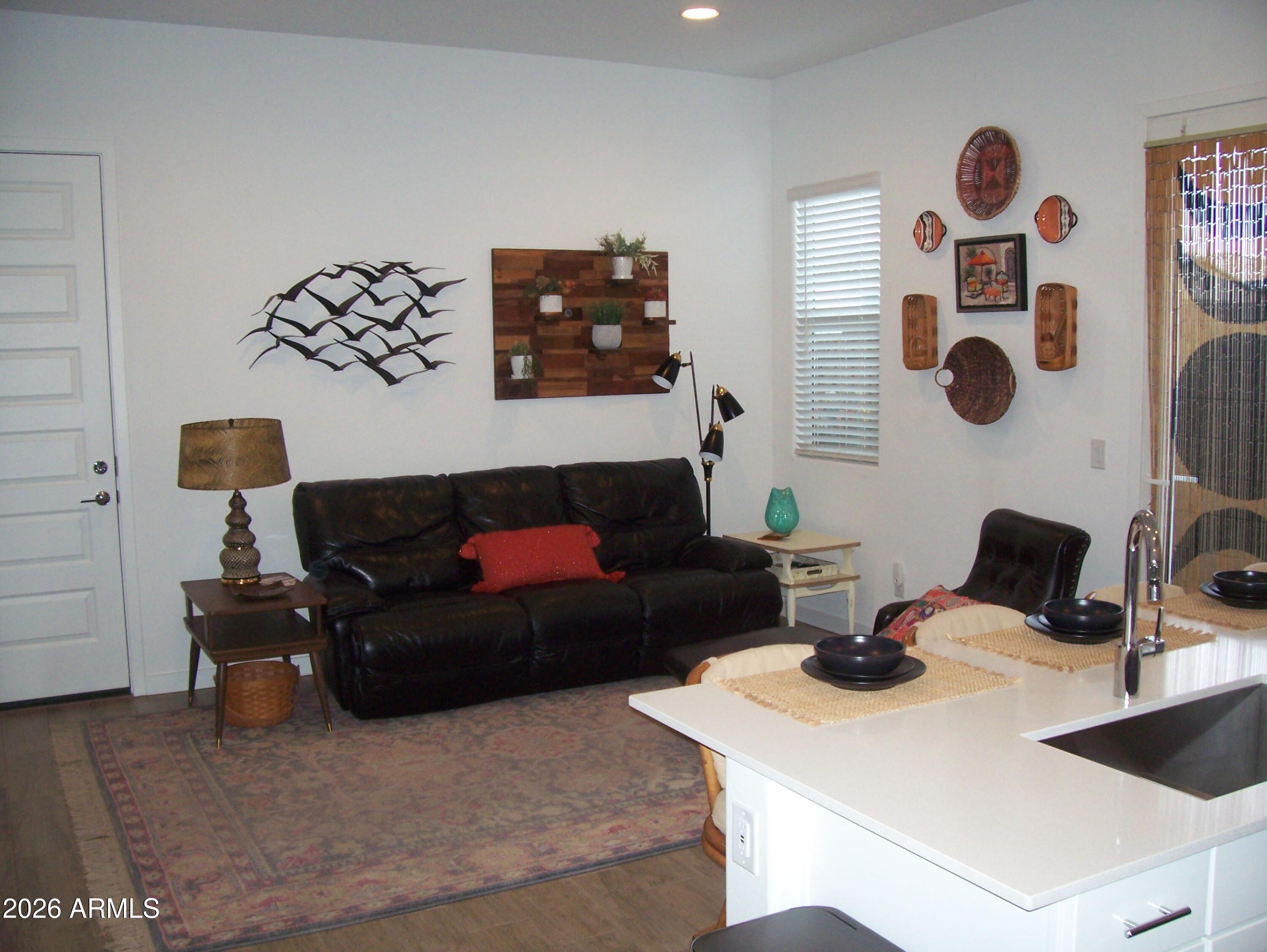 3255 West Peak View Road Phoenix, AZ 85083 - Photo 11 of 46 a living room with furniture and wall painting