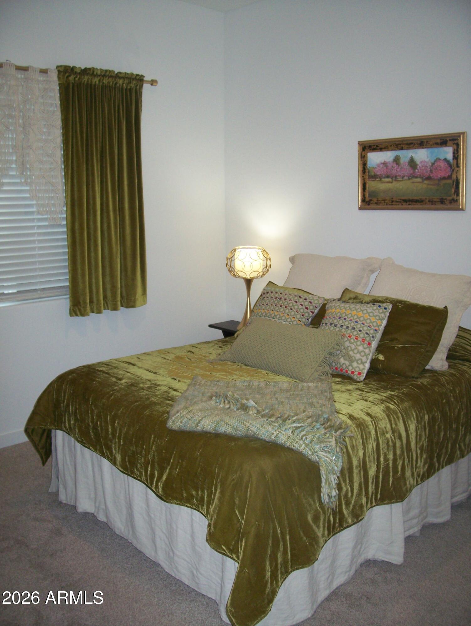 3255 West Peak View Road Phoenix, AZ 85083 - Photo 14 of 46 a bed sitting in a bedroom next to a window