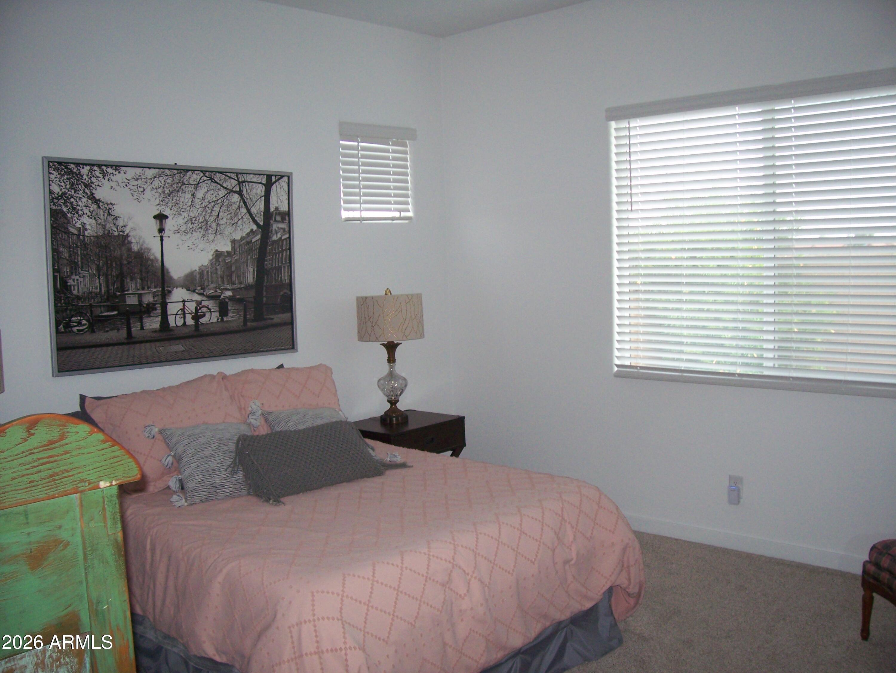 3255 West Peak View Road Phoenix, AZ 85083 - Photo 29 of 46 a bedroom with a bed and a painting on the wall