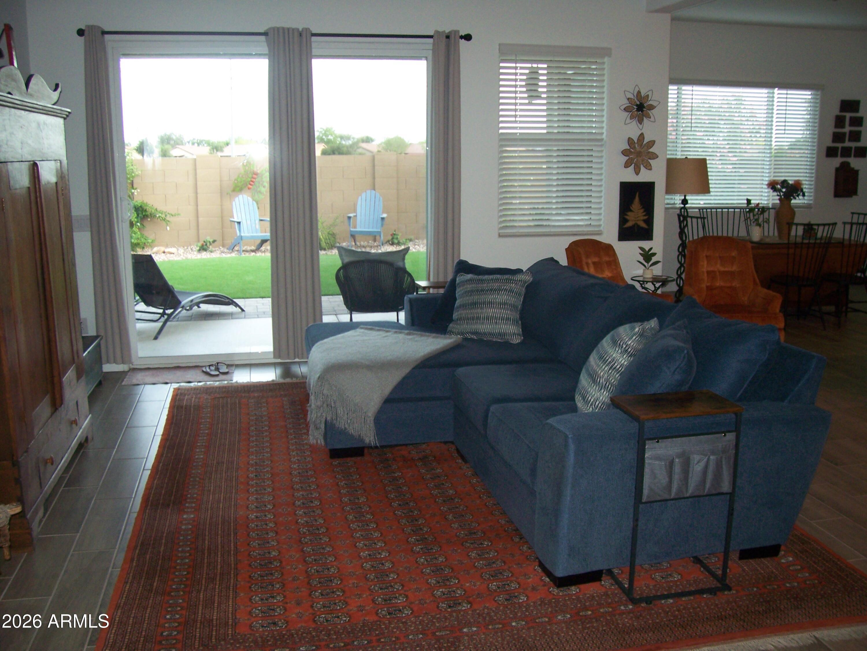 3255 West Peak View Road Phoenix, AZ 85083 - Photo 30 of 46 a living room with furniture and a large window