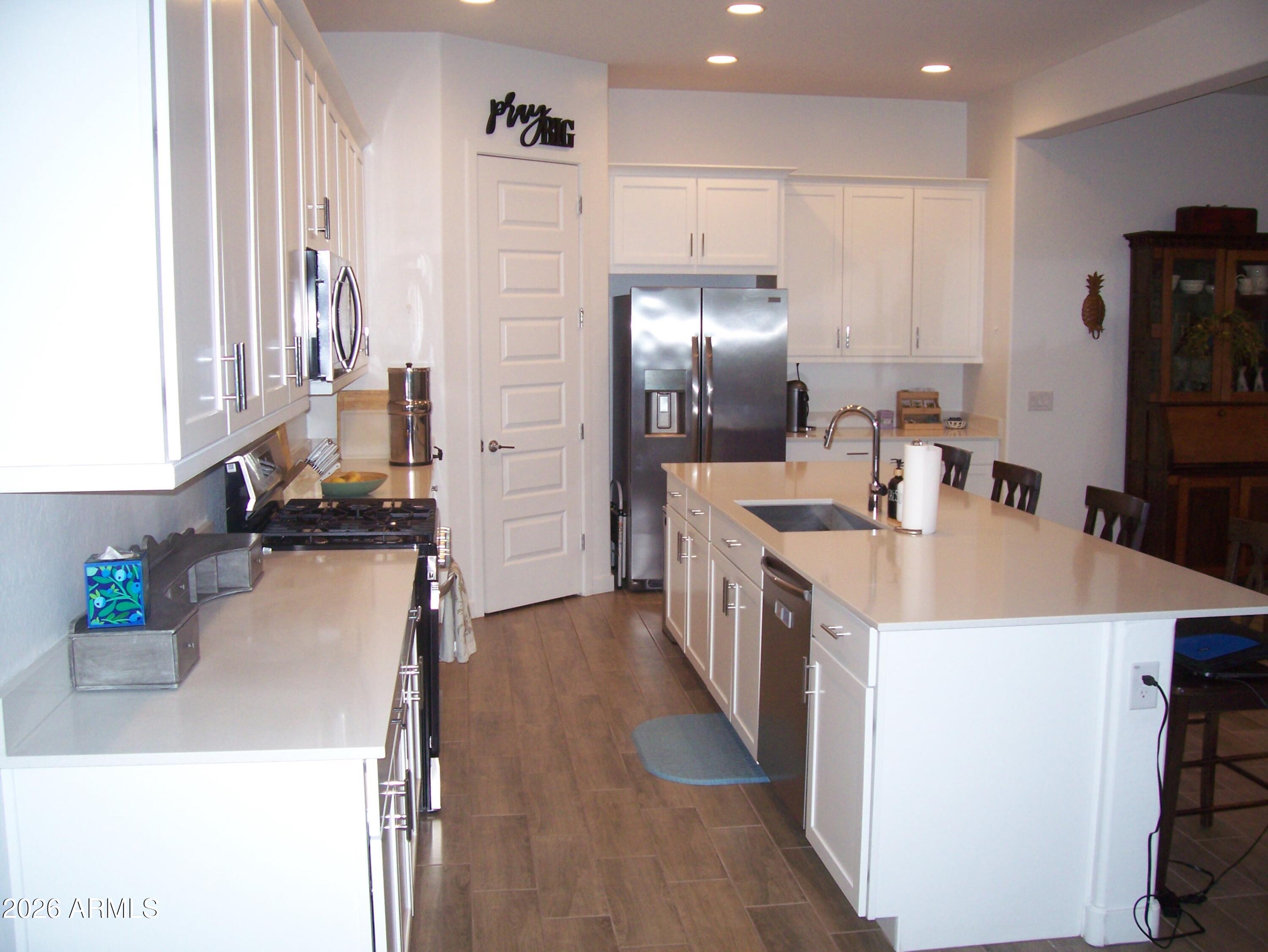 3255 West Peak View Road Phoenix, AZ 85083 - Photo 31 of 46 a kitchen with kitchen island a sink stove and refrigerator