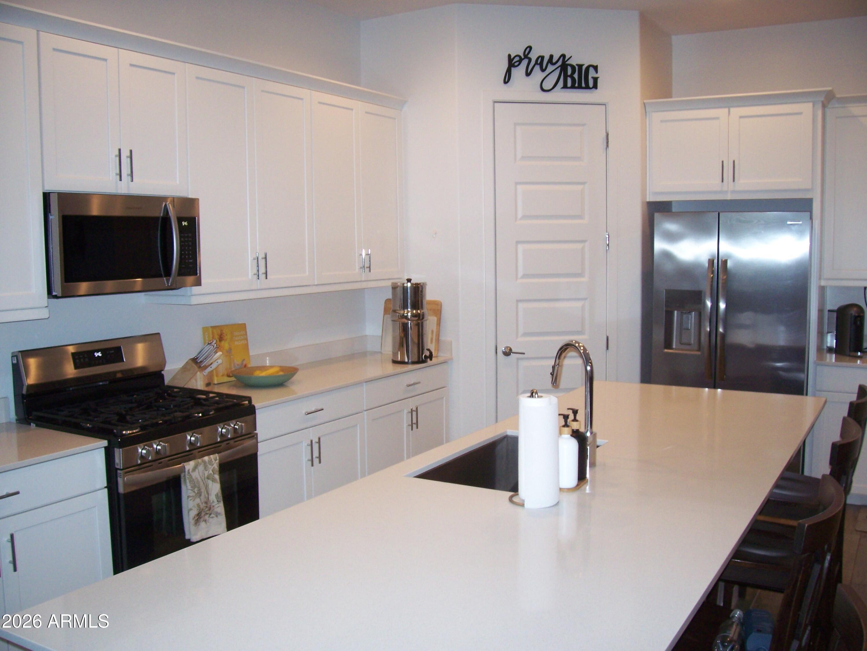 3255 West Peak View Road Phoenix, AZ 85083 - Photo 32 of 46 a kitchen with stainless steel appliances granite countertop a sink stove and refrigerator