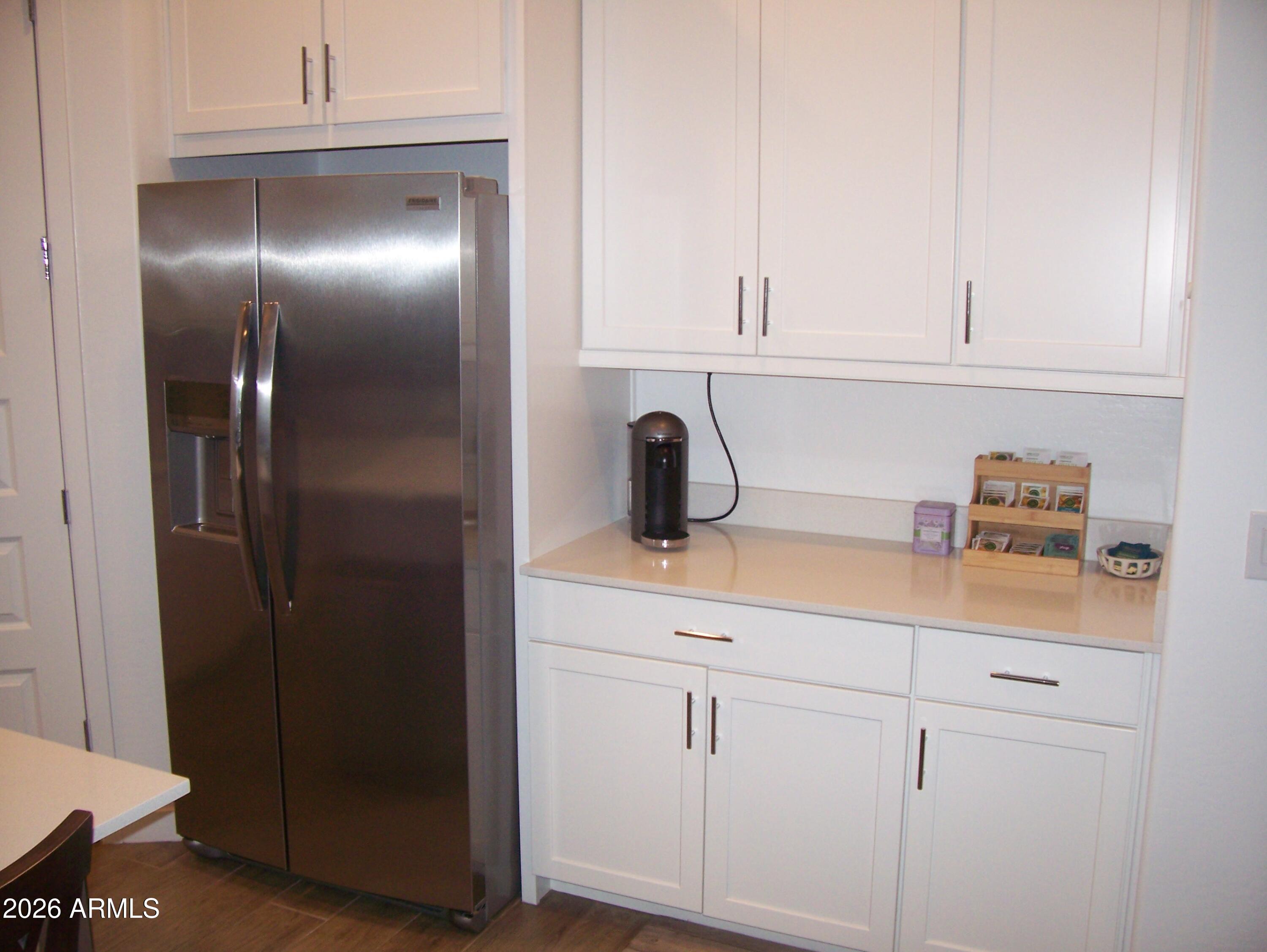 3255 West Peak View Road Phoenix, AZ 85083 - Photo 33 of 46 a kitchen with a refrigerator and white cabinets