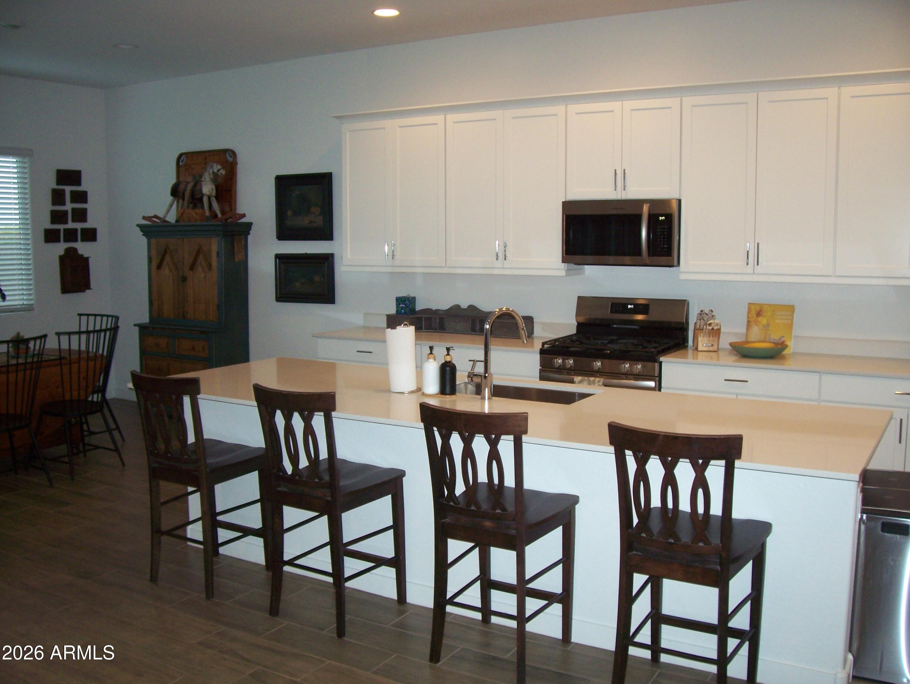 3255 West Peak View Road Phoenix, AZ 85083 - Photo 34 of 46 a kitchen with stainless steel appliances granite countertop a dining table and chairs