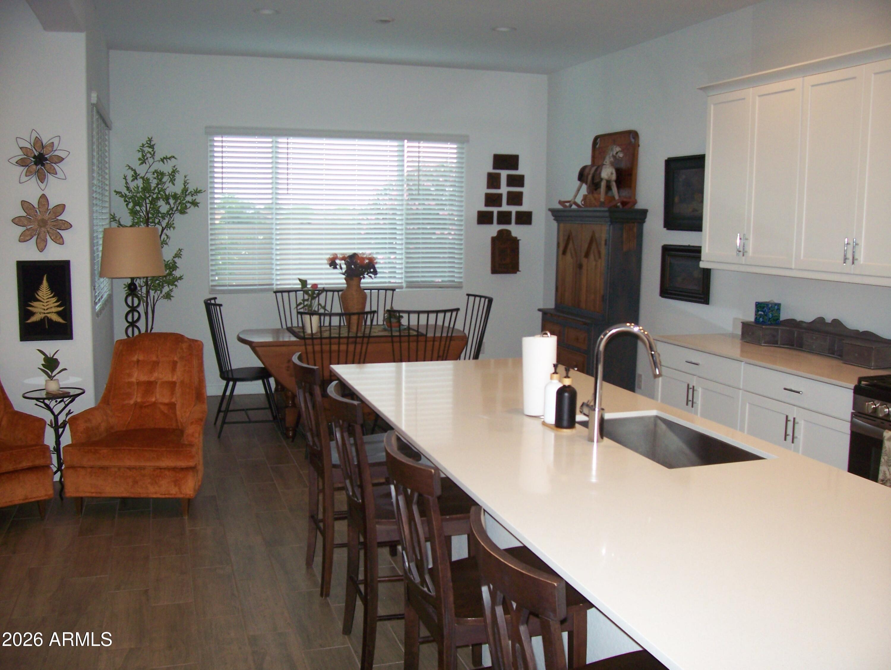3255 West Peak View Road Phoenix, AZ 85083 - Photo 35 of 46 a kitchen with a table chairs stove and refrigerator