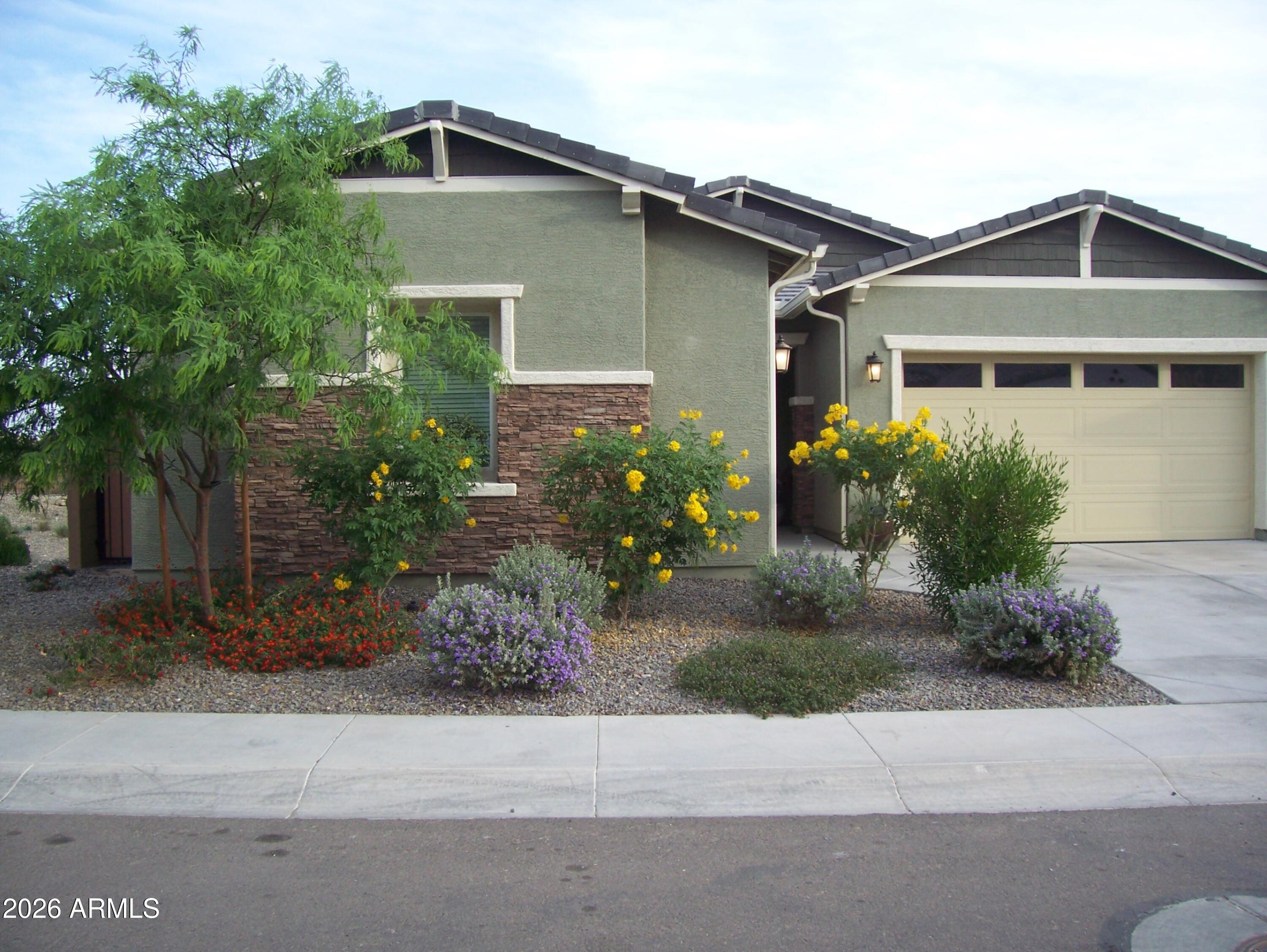 3255 West Peak View Road Phoenix, AZ 85083 - Photo 40 of 46 a front view of a house with a yard and a garage