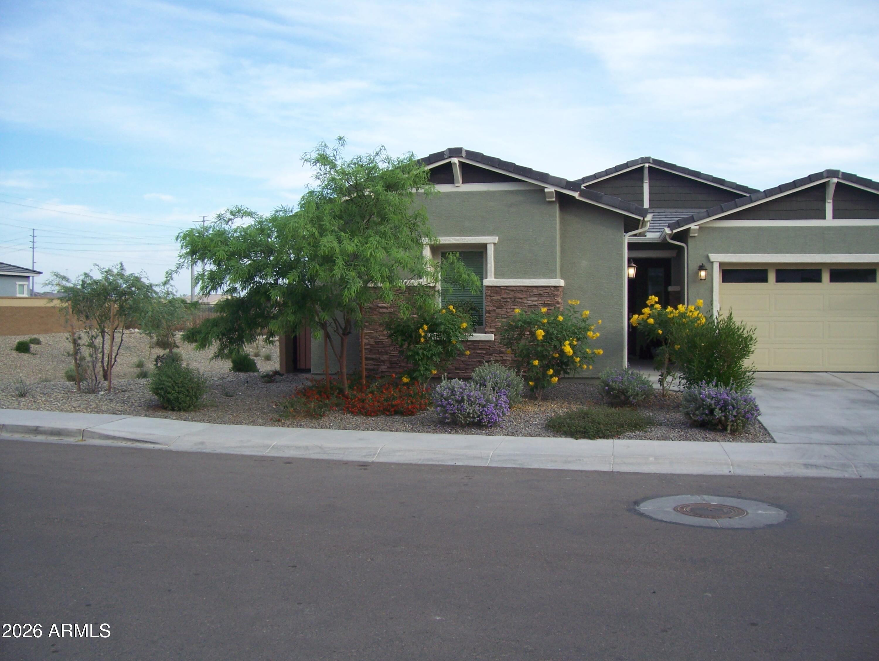 3255 West Peak View Road Phoenix, AZ 85083 - Photo 42 of 46 a front view of a house with a yard and a garage