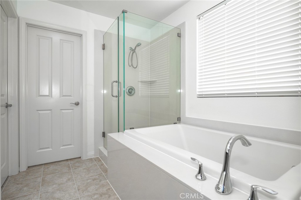 31 Bell Chime Irvine, CA 92618 - Photo 14 of 28 a bathroom with a tub and shower