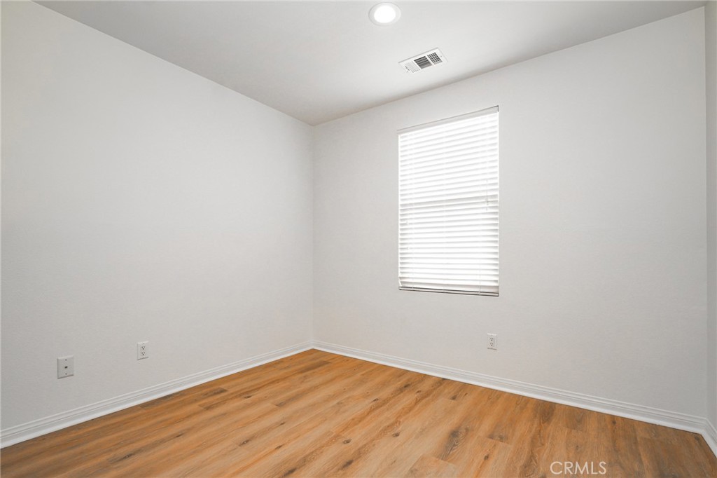 31 Bell Chime Irvine, CA 92618 - Photo 17 of 28 an empty room with wooden floor and windows