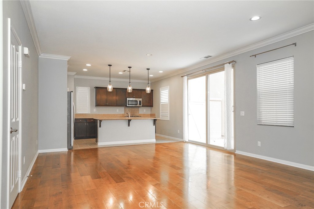 31 Bell Chime Irvine, CA 92618 - Photo 2 of 28 a view of a kitchen with kitchen island a counter top space stainless steel appliances and a window
