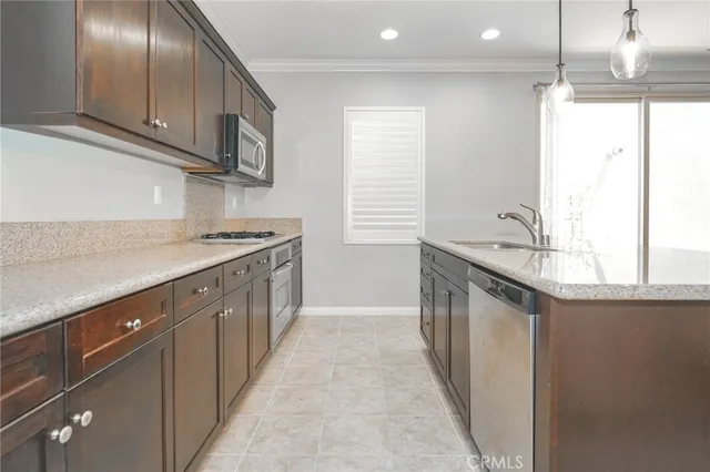 a kitchen with stainless steel appliances granite countertop a sink and a stove