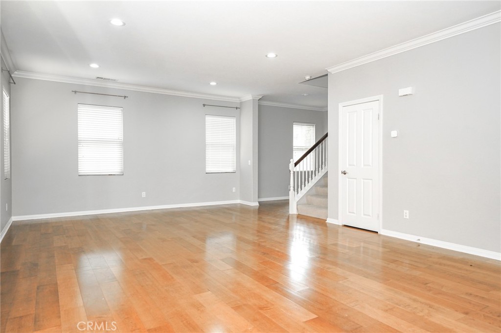 31 Bell Chime Irvine, CA 92618 - Photo 7 of 28 a view of empty room with wooden floor and fan