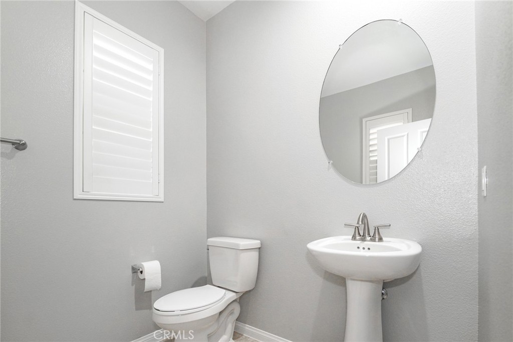 31 Bell Chime Irvine, CA 92618 - Photo 9 of 28 a bathroom with a toilet sink and mirror