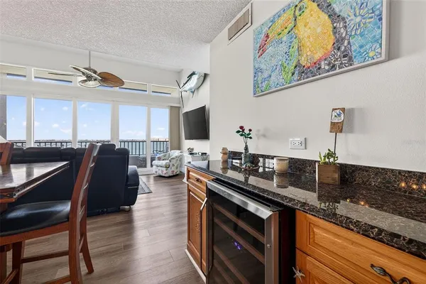 a living room with furniture and a floor to ceiling window