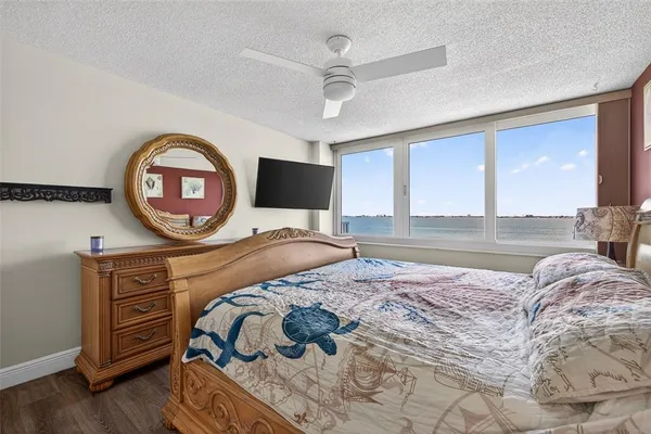 a bedroom with a bed and a large window