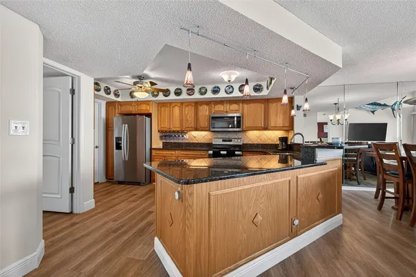a kitchen with stainless steel appliances granite countertop a sink and cabinets