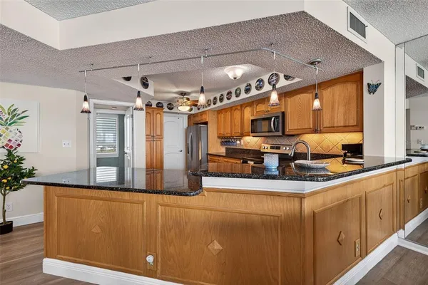 a kitchen with stainless steel appliances granite countertop a sink and cabinets