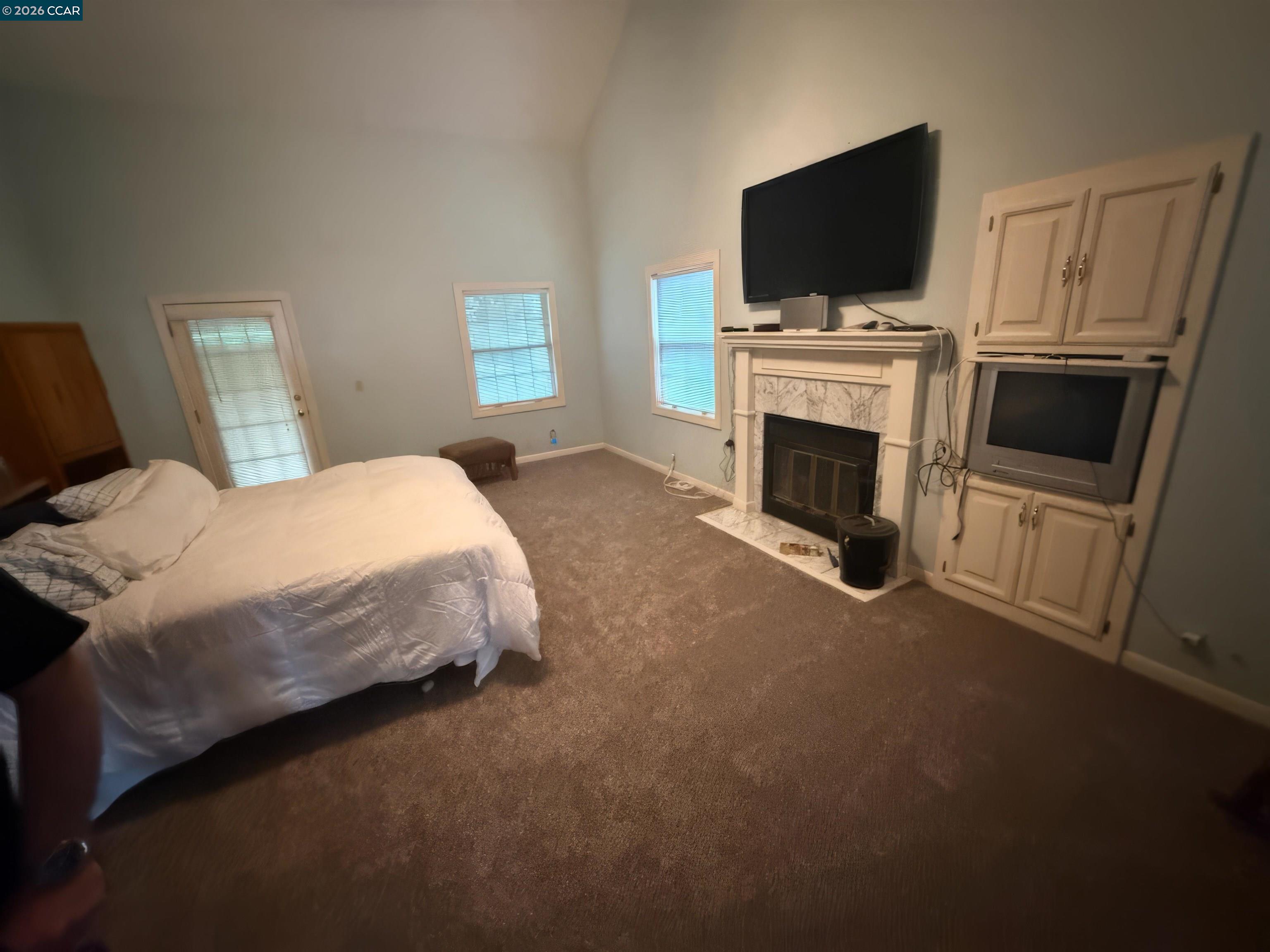 10580 Dickson Road Plymouth, CA 95669 - Photo 23 of 64 a spacious bedroom with a bed and a flat screen tv
