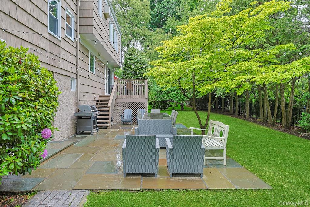 305 Stratton Road New Rochelle, NY 10804 - Photo 30 of 32 a view of a patio with table and chairs potted plants and large tree