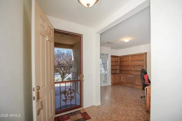 a view of a hallway with closet and bathroom