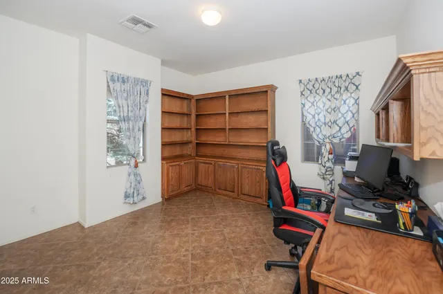 a view of a livingroom with furniture and a workspace