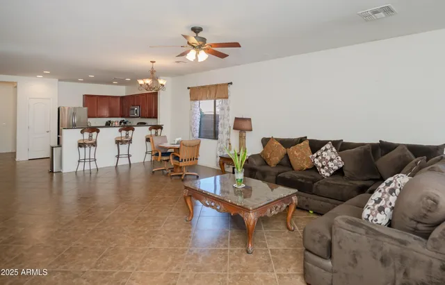 a living room with furniture and a chandelier